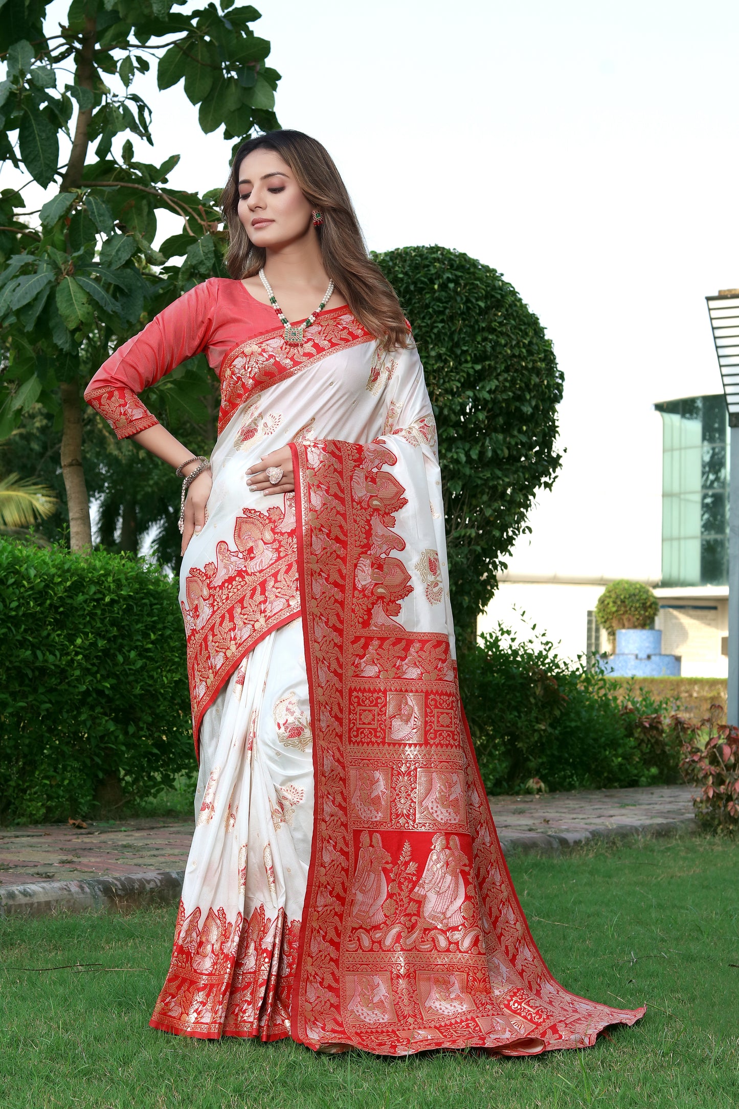 THIS EXQUISITE WORK OF ART IN BANARASI SILK FEATURES INTRICATE FLORAL DETAILS AND ZARI ON ALL FOUR SIDES SAREE